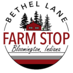 Bethel Lane Farm Stop logo: a red barn among evergreens inside a round badge
