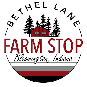 Bethel Lane Farm Stop logo: a red barn among evergreens inside a round badge