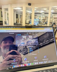 David Martin testing the fast Wi-Fi speeds on his laptop at Brightside Cafe, Bloomington, Indiana, with Speedtest results displayed on the screen.
