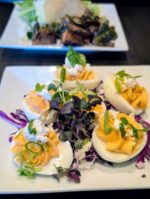 A colorful twist on classic deviled eggs, elevated with fresh herbs and crumbled cheese.