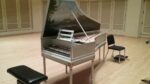 A gray harpsichord featuring a painted landscape inside the raised lid, reflecting the decorative craftsmanship of Robertson Harpsichords.
