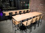 Modern wood table seating inside Soma Coffeehouse with exposed brick walls in Bloomington, Indiana