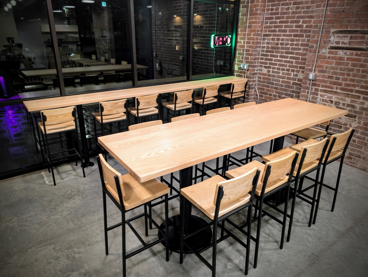 Modern wood table seating inside Soma Coffeehouse with exposed brick walls in Bloomington, Indiana