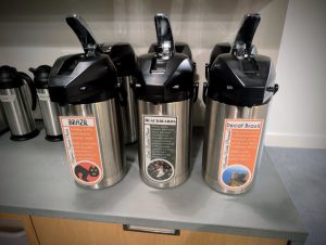 Airpots labeled Brazil, Blackbeards, and Decaf Brazil drip coffee at Soma Coffeehouse in Bloomington