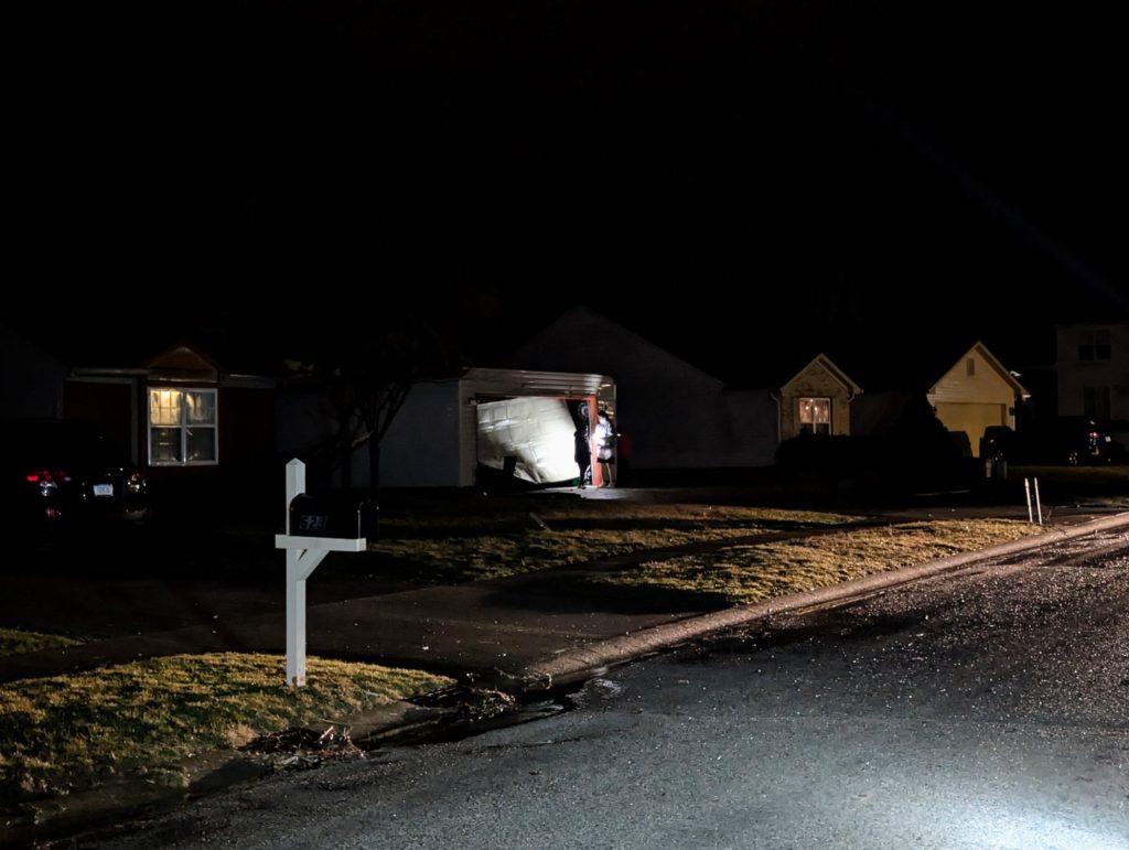 A neighbor's house in Bloomington's Fieldstone neighborhood with roof missing and garage door destroyed after a tornado on February 19, 2026.