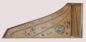 Traditional French-style harpsichord soundboard painting with pastel floral motifs in light blue, pink, and soft gray-white tones